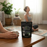 shopnathans.com Pure Infinity Botanicals Green Maeng Da Kratom capsules pouch on a table with a steaming cup of tea
