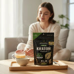 shopnathans.com Pure Infinity Botanicals Green Maeng Da kratom powder bag on a wooden tray with a warm drink