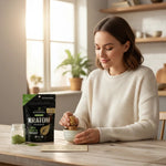 A woman whisking green kratom powder in a bowl next to a shopnathans.com Pure Infinity Botanicals pouch in a kitchen.