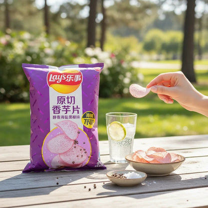 shopnathans.com Lay's Taro Chips with Black Pepper in a purple 60g bag on an outdoor table with a bowl of chips