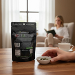 shopnathans.com Pure Infinity Botanicals Trainwreck Kratom capsules in a black resealable bag on a wooden table.