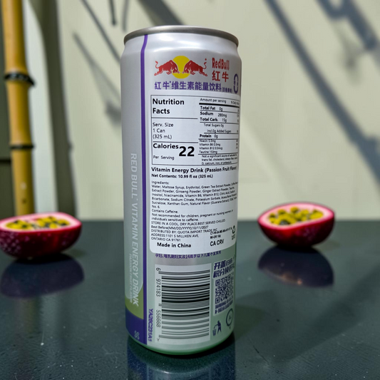shopnathans.com Red Bull passion fruit energy drink can showing nutrition facts label with sliced fruit background
