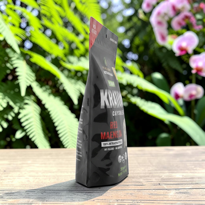shopnathans.com Pure Infinity Botanicals Red Maeng Da Kratom capsules in a black stand-up pouch on a wooden surface.
