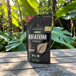 shopnathans.com Pure Infinity Botanicals Red Maeng Da Kratom powder in an 8oz resealable pouch on a wooden table.