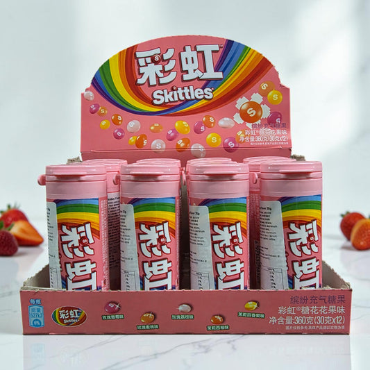 shopnathans.com Skittles Flowery Fruity flavor candy bottles in a pink display box with fresh strawberries