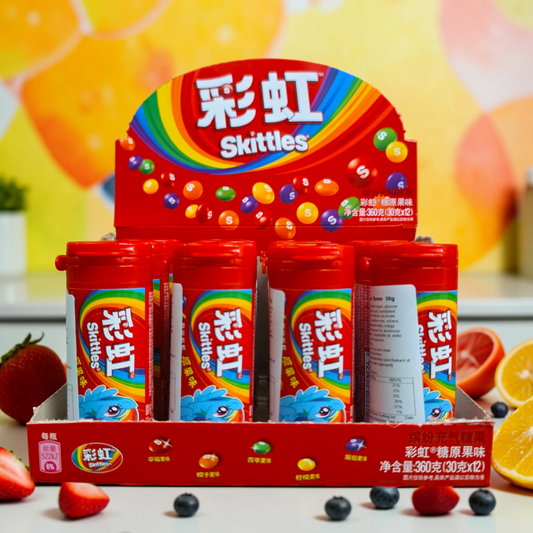 shopnathans.com Skittles fruit flavor candy bottles in a red display box featuring a vibrant rainbow logo