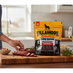 shopnathans.com Tillamook Zero Sugar Original smoked sausage sticks in a 4oz bag on a wooden cutting board