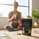 shopnathans.com Pure Infinity Botanicals Trainwreck Kratom powder pouch on a table with a woman meditating in background