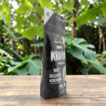 shopnathans.com Pure Infinity Botanicals White Maeng Da Kratom powder in a black resealable pouch on a wooden table.
