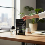 shopnathans.com Pure Infinity Botanicals White Maeng Da Kratom powder in a black resealable pouch on a wooden desk.